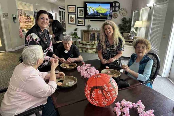 Residents and staff engaged in an activity together