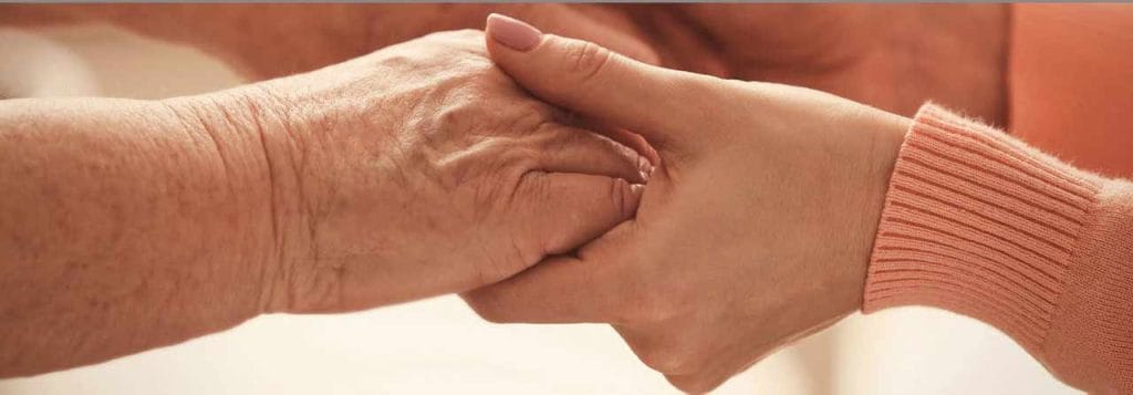 Two hands holding each other, showing connection