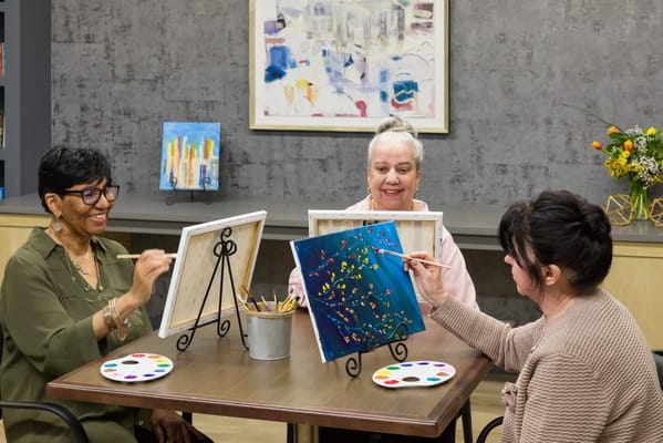 Residents engaged in a painting activity in a communal area