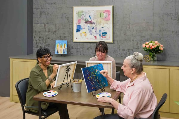 Residents engaging in a painting activity in a common area