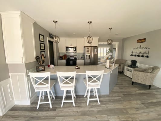 Bright kitchen area with modern appliances and seating