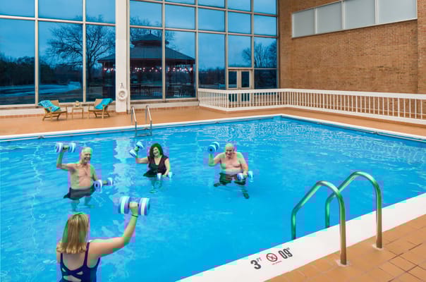 Residents participating in a water exercise class in an indoor pool