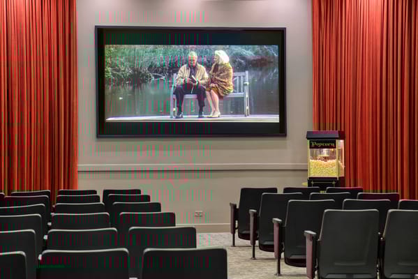 Interior view of a movie screening room with empty chairs