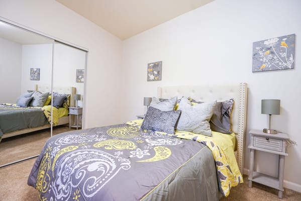 Cozy bedroom with decorative pillows and artwork