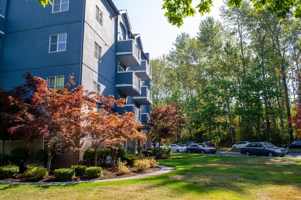 Exterior view of a senior living facility with landscaped garden