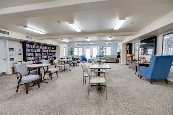 Bright common area with bookshelves and seating