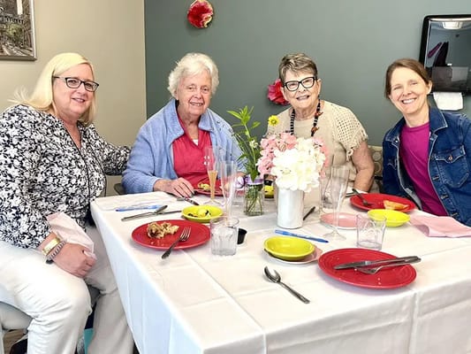 Residents enjoying a meal together at a dining table