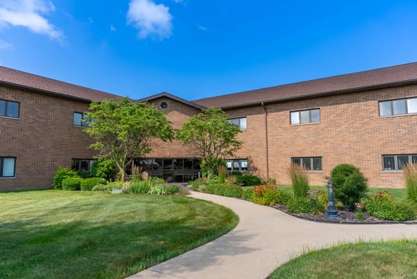 Exterior view of the facility surrounded by landscaped gardens