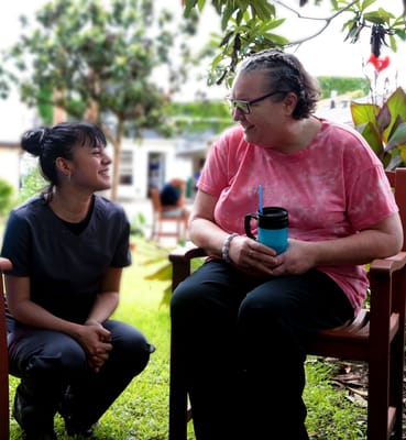Staff member interacting with a resident in an outdoor space