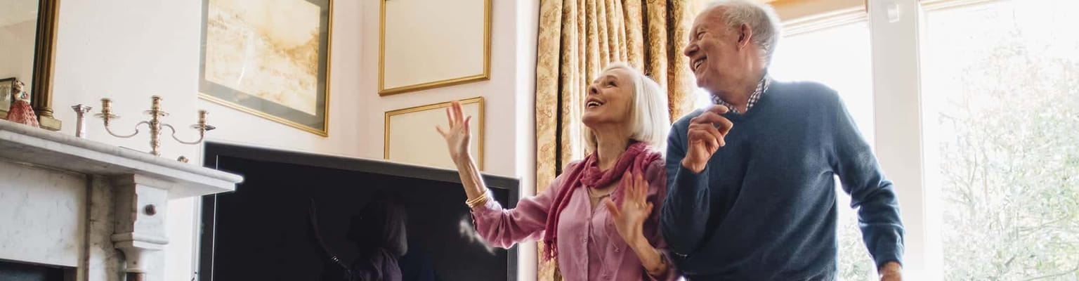 Two residents happily interacting in a cozy living room