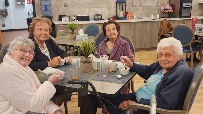 Residents enjoying dessert at a common area table