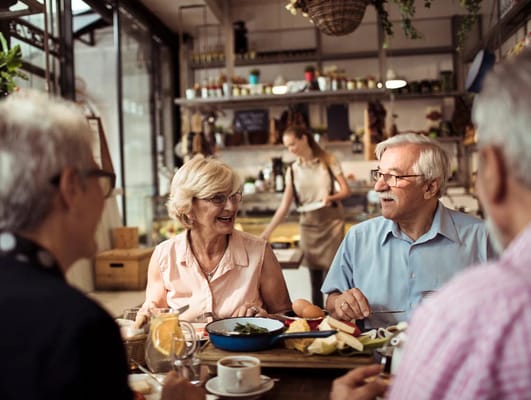 Residents enjoying a meal in a dining area