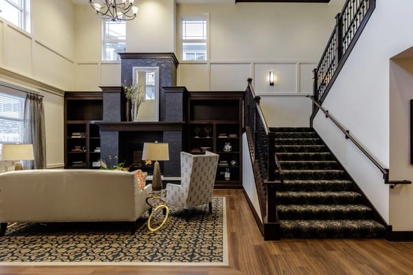 Spacious common area with seating and staircase