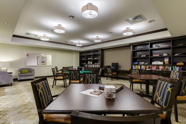 Interior view of a common area with seating and bookshelves