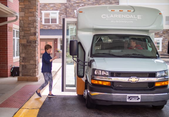 Resident boarding a facility shuttle bus