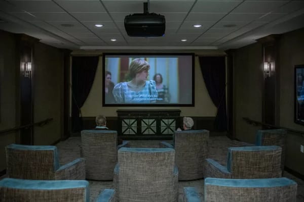 Residents watching a movie in a cozy theater room