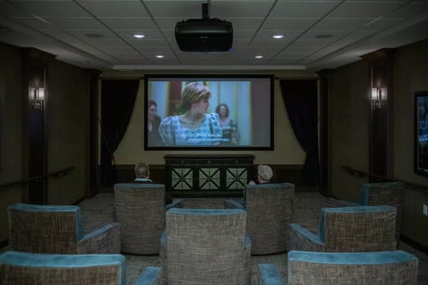 Residents watching a movie in a common area theater