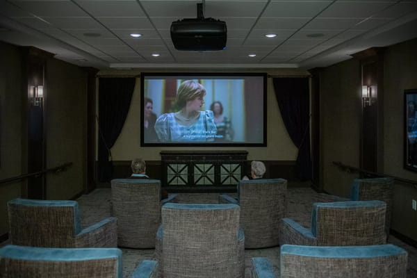 Residents enjoying a movie in the theater room