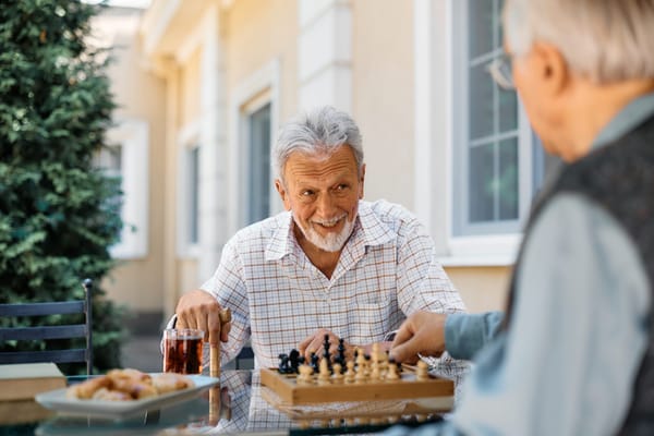 Two men playing chess outdoors