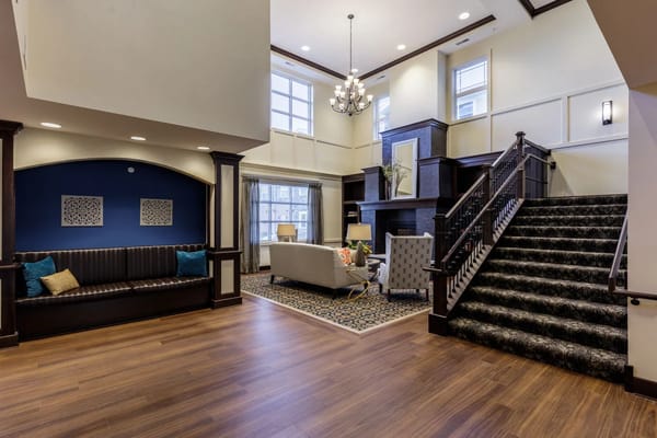 Bright and welcoming common area with seating and staircase