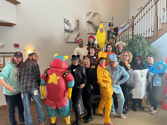 Staff and residents in costumes at a community event