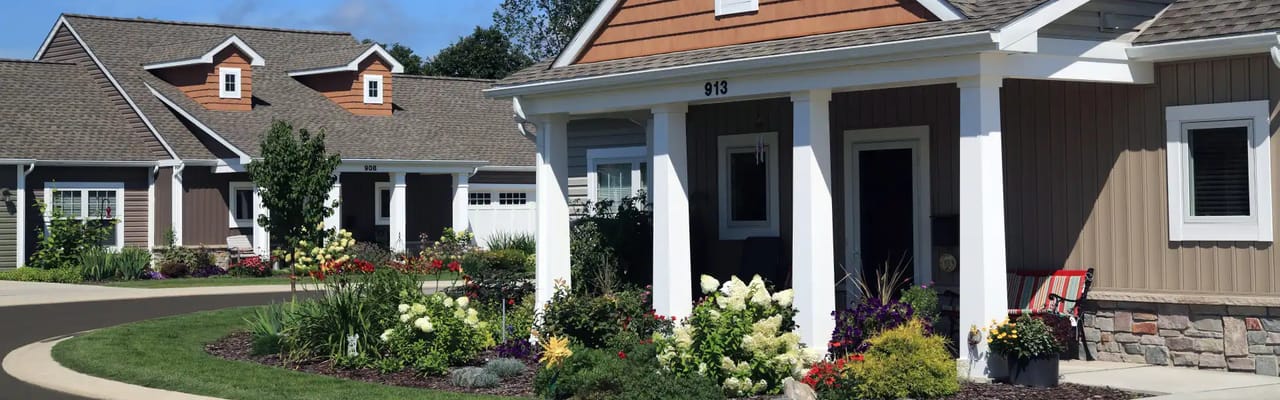 Beautiful cottages with flower gardens in a senior living community.