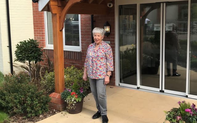 Resident standing outside the facility entrance