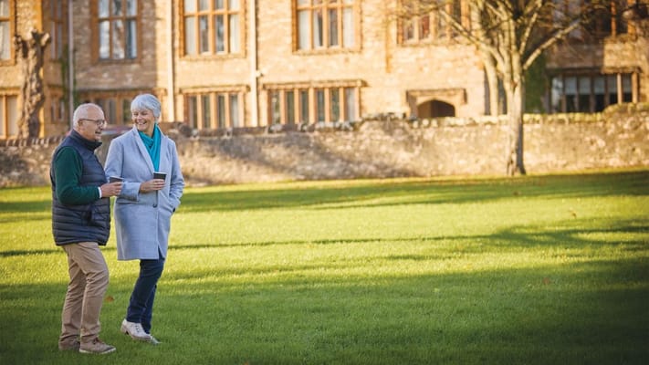 Couple enjoying a walk in the facility's garden