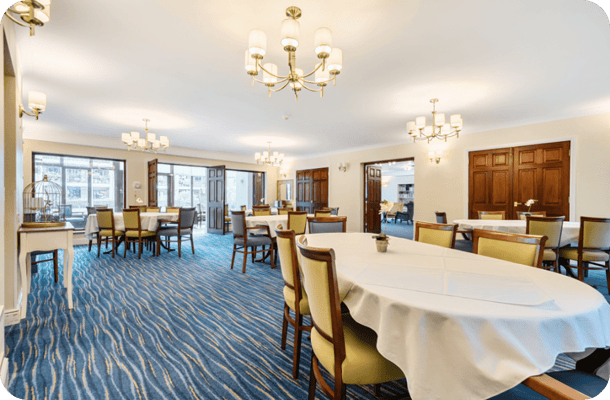 Dining area with tables and chairs in a well-lit room