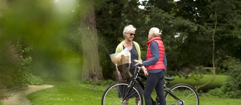 Two residents chatting in a garden area