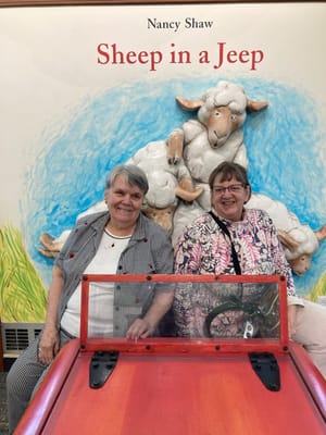 Two residents posing in an activity area