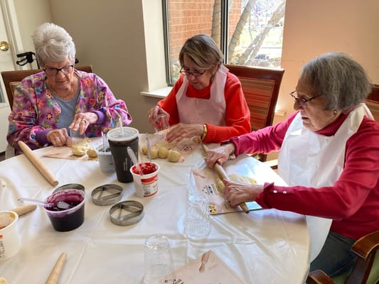 Residents participating in a baking activity at the facility