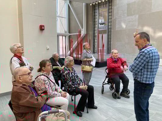 Residents listening to a speaker in a common area