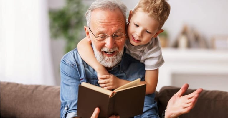 Senior reading a book with a child