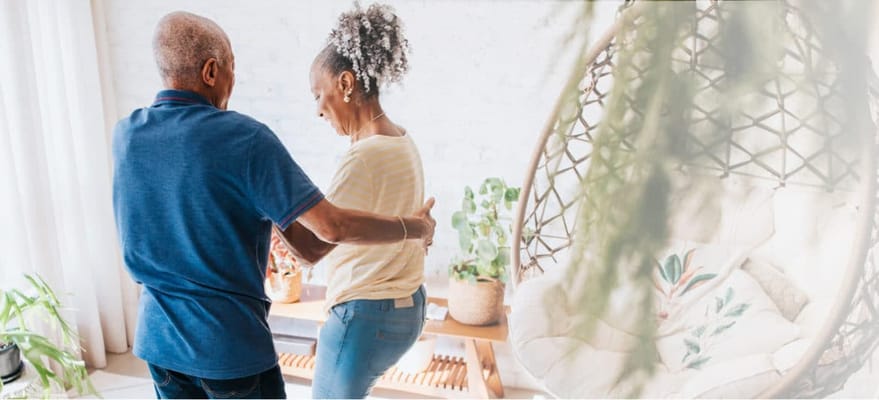 Couple dancing in a cozy indoor setting