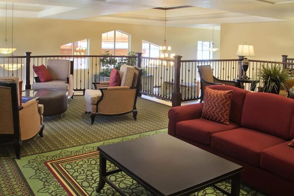 Bright lounge area with comfortable seating and plants