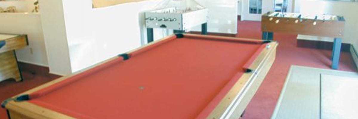 Interior game room with pool table and foosball table