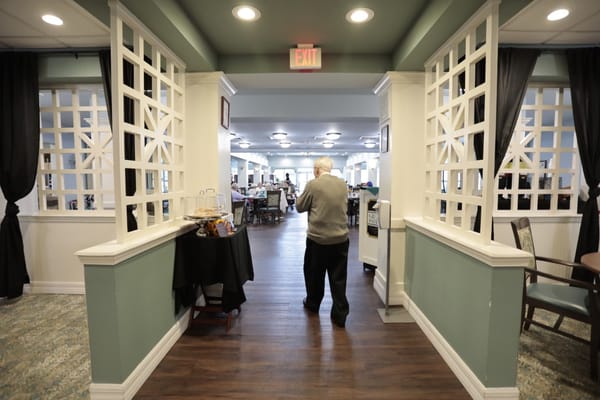 A resident walking through a common area of the facility