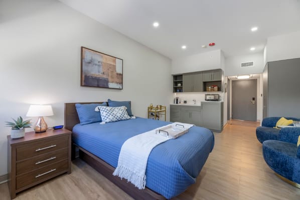 Cozy private room with a bed and kitchenette