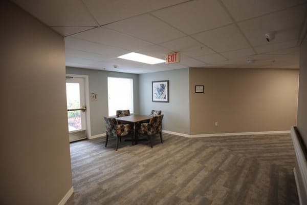 Bright common area with a table and chairs