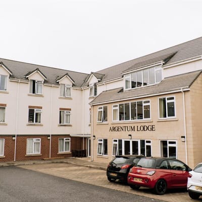 Exterior view of Argentum Lodge with parking area