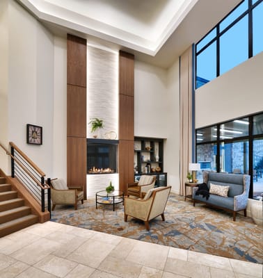 Bright lobby area with comfortable seating and fireplace