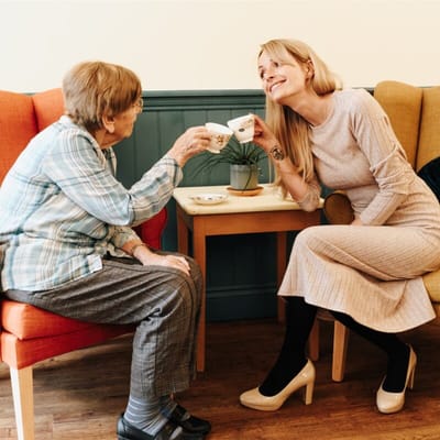 Resident and staff member enjoying tea together