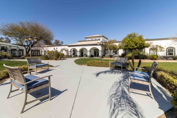Outdoor seating area with pathway and building in background