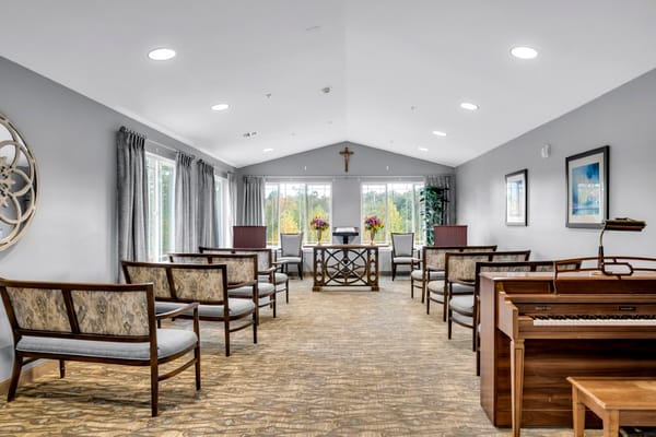 Bright lounge area with seating and a piano