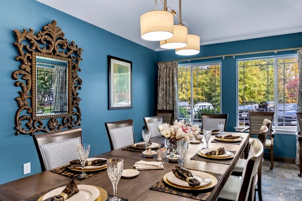 Elegant dining room with blue walls and decorative mirror