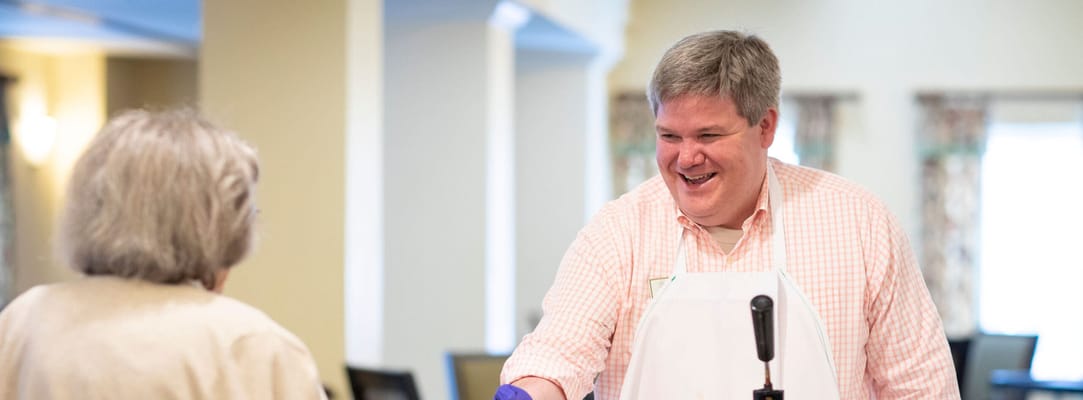 Staff member interacting with a resident in a communal area