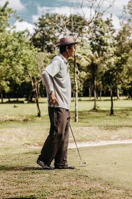 A senior man walking on a golf course
