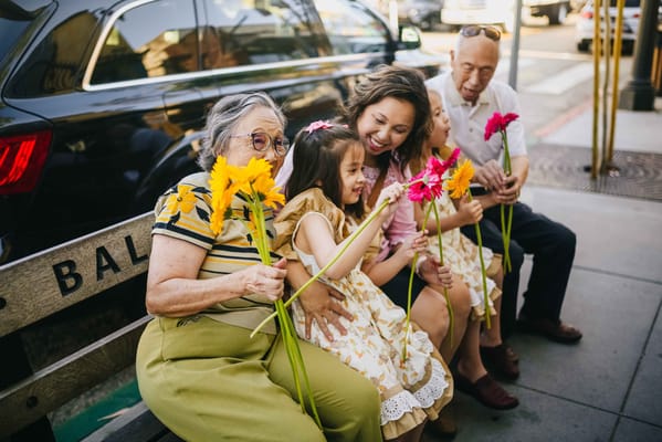 Residents and family enjoying flowers on a bench