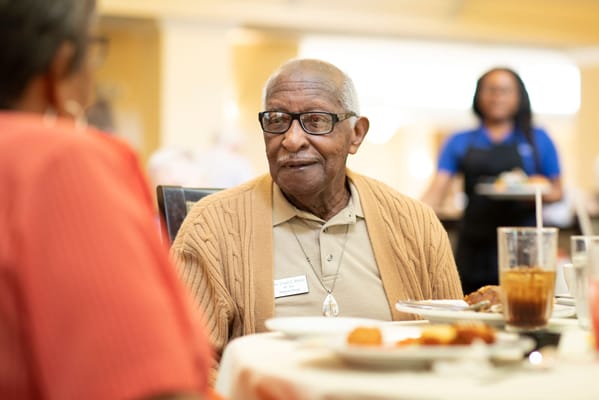 Residents enjoying a meal together in the dining area